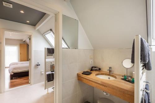 a bathroom with a sink and a mirror at Apollonia in Aalter