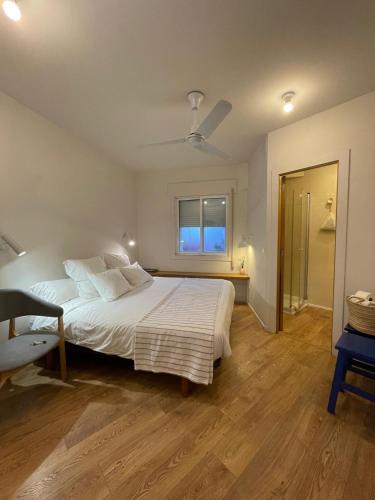 a bedroom with a white bed and a window at Lar Atlántica in Vigo