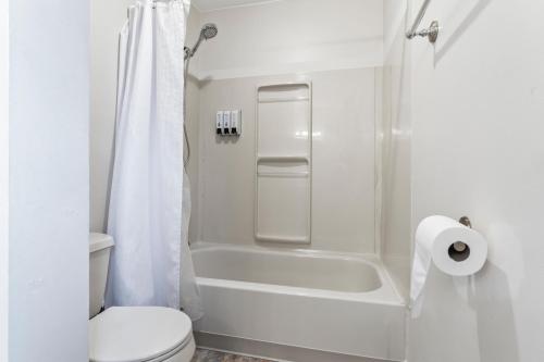 a white bathroom with a shower and a toilet at Simple Deluxe Private Room in Anchorage