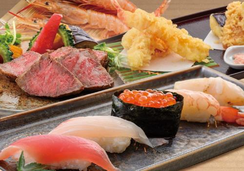 a tray of sushi with different types of meat and vegetables at Hotel Monterey Okinawa Spa & Resort in Onna