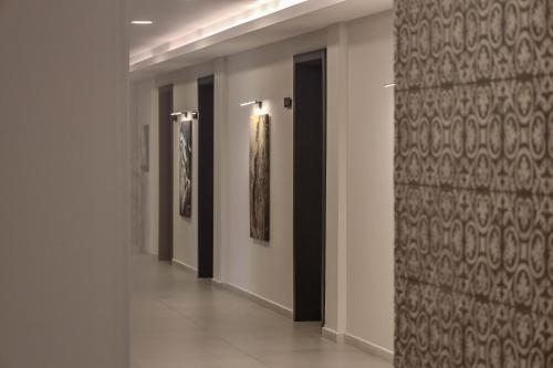 a hallway of a building with paintings on the wall at Nafron Hotel in Prizren