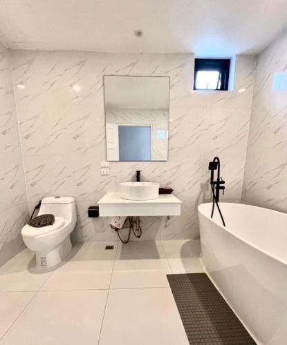a bathroom with a toilet and a sink and a tub at patong sunset villa Phuket in Patong Beach