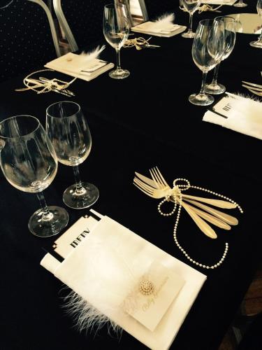 a black table with wine glasses and napkins at Näsby Slott in Täby