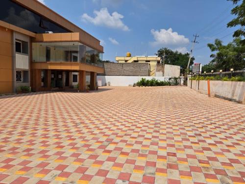 an empty parking lot in front of a building at Hotel Badami Court in Badami