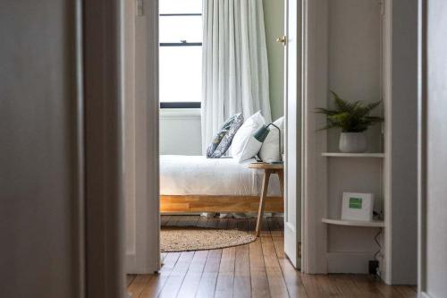 a bedroom with a bed and a window at Modern 3-Bed Coastal Escape in Burnie