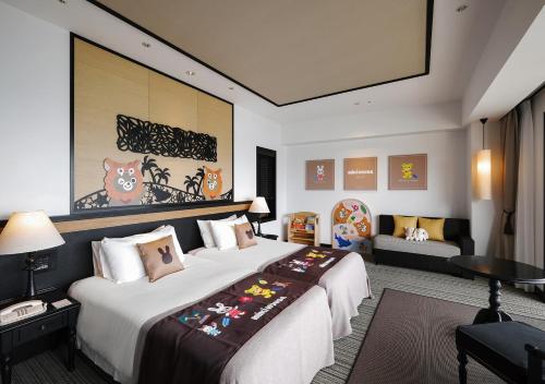 a hotel room with a large bed and a couch at Hotel Monterey Okinawa Spa & Resort in Onna
