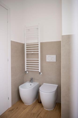 a bathroom with a white toilet and a sink at Biffi 2 - Garbatella Rooms in Rome