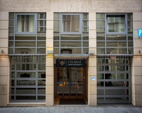 an entrance to a building with a sign on it at Charm Hotel Budapest - formerly Boutique Hotel Budapest in Budapest