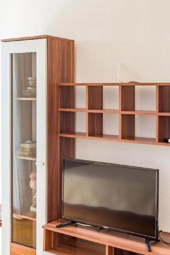 a flat screen tv sitting in a living room at Apartments and Rooms Happiness in Tučepi