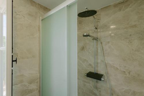 a shower with a glass door in a bathroom at Dipaton House in Vasa 2 in Vasa Kilaniou