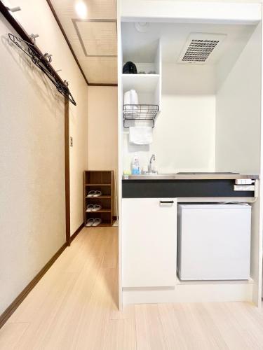 a kitchen with white cabinets and a sink at Toko inn Japanese-style room popularity in Tokyo