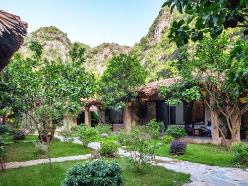 a house with a garden in front of it at Cozy Beer Garden Homestay in Ninh Binh
