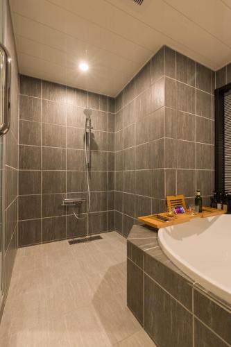 a bathroom with a tub and a shower at FARMSTAY miyuki-street "Hotaru" in Kugumiya