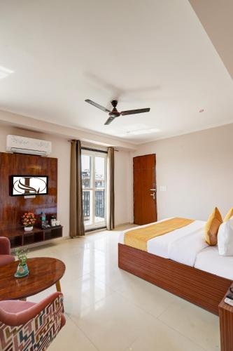 a bedroom with a large bed and a table at Limewood Stay Oasis - Golf Course Road in Gurgaon