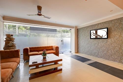 a living room with a couch and a table at Limewood Stay Oasis - Golf Course Road in Gurgaon