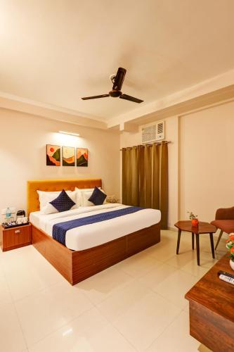 a bedroom with a large bed and a couch at Limewood Stay Oasis - Golf Course Road in Gurgaon