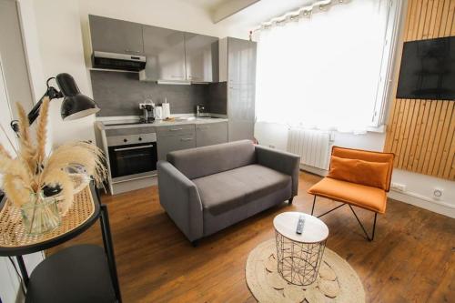 un salon avec un canapé et une table dans l'établissement NEW! St Martin 52B -Grand studio lumineux - wifi, à Angoulême