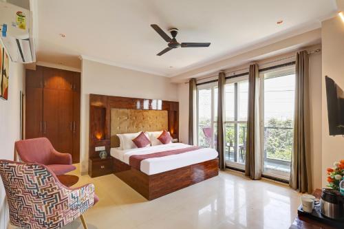 a hotel room with a bed and a balcony at Limewood Stay Oasis - Golf Course Road in Gurgaon