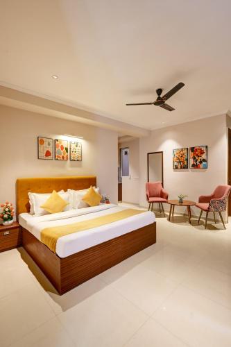 a bedroom with a large bed and a table at Limewood Stay Oasis - Golf Course Road in Gurgaon