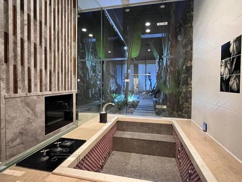 a bathroom with a sink and a stove in a room at Moonlight Motel in Taichung