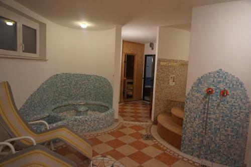 a rendering of a room with a tub and stairs at Hotel & Residence Sylvanerhof in Chiusa