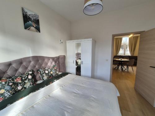 a bedroom with a large bed and a living room at Modern apartment near Avenue Louise in Brussels