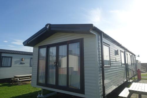 a tiny house with a roof on top of it at Red Lion Holiday Park in Arbroath