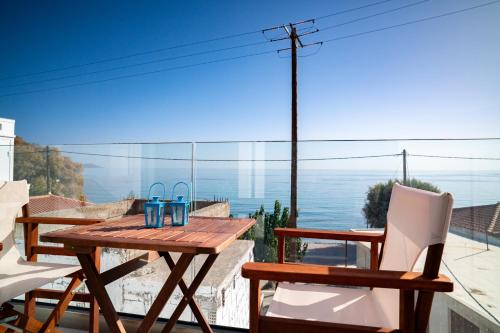 a table and chairs with a view of the ocean at Kontemare Seascape in Koumeika