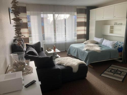 a bedroom with a bed and a couch at Kiek mol wedder in in Borkum