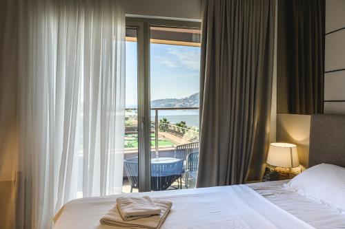 a hotel room with a bed and a view of the ocean at Budva Harmonia in Boreti