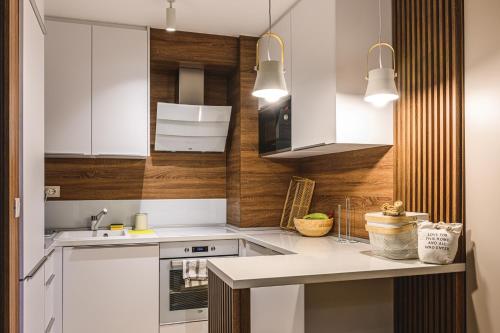 a kitchen with white cabinets and a counter top at Budva Harmonia in Boreti