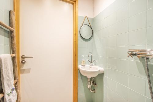 a bathroom with a sink and a mirror at El Paller De Cal Dominguet in Espluga Calva