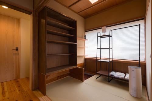a room with a book shelf and a window at FARMSTAY miyuki-street "Hotaru" in Kugumiya