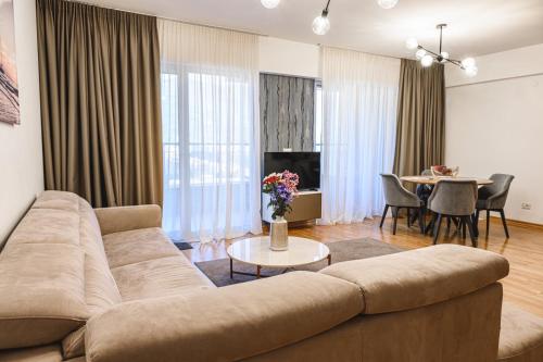 a living room with a couch and a table at Budva Harmonia in Boreti