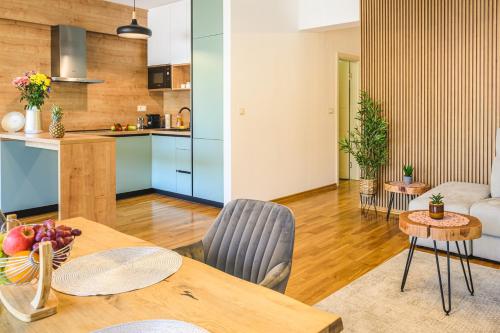a kitchen and a living room with a table and chairs at Budva Harmonia in Boreti