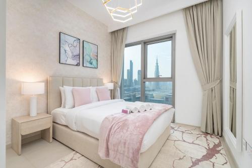 a bedroom with a large bed and a large window at Free housekeeping visits during your stay - StayShort - Beautiful 2-BR Flat in Downtown Luxury City Living at Its Best in Dubai