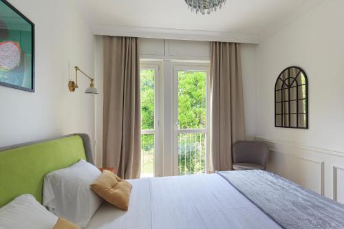 a bedroom with a white bed and a window at Sense Rooms in Baveno