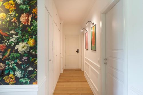 a hallway with a wall mural of flowers at Sense Rooms in Baveno