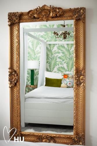 a mirror with a white bed in a room at Sky Marina Suite Penthouse in Hull