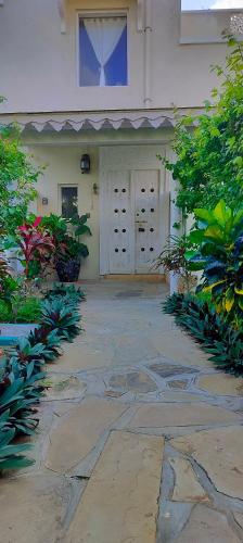 a building with two doors and plants in front of it at Casa Maridadi in Watamu