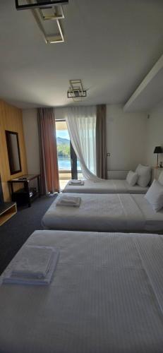 a hotel room with two beds and a window at Orlovo gnezdo in Ljubovija
