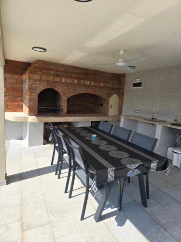 a room with a table and chairs and a brick wall at Orlovo gnezdo in Ljubovija