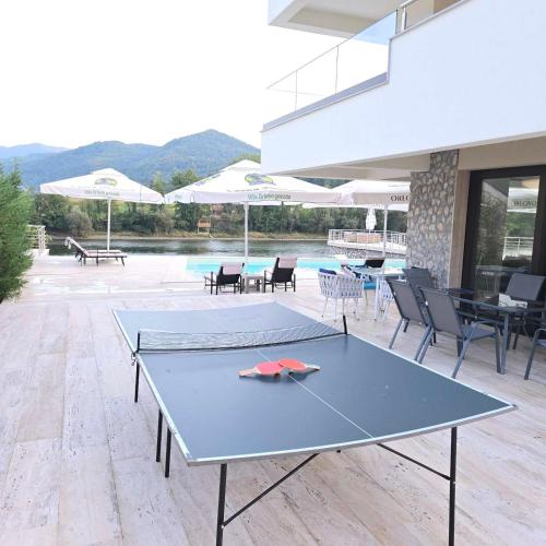a ping pong table in the middle of a patio at Orlovo gnezdo in Ljubovija