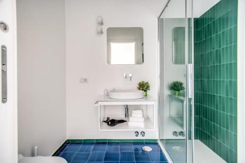 a bathroom with a sink and a glass shower at Villa La Luce 5 Bedrooms in the Town Center by Feeling Italy in Massa Lubrense