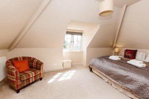 a bedroom with a bed and a chair at Westholme Lodge in Minehead