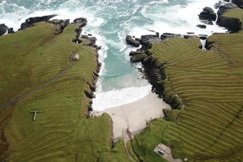 an aerial view of the ocean and a beach at Flat in Eoropie, Ness, Isle of Lewis in Port of Ness