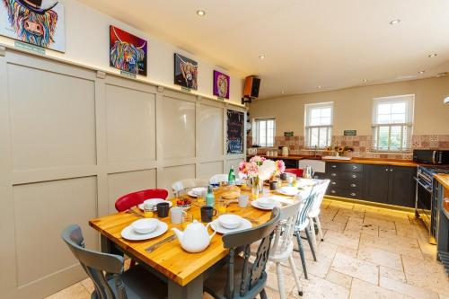 a large dining room with a table and chairs at Westholme Lodge in Minehead