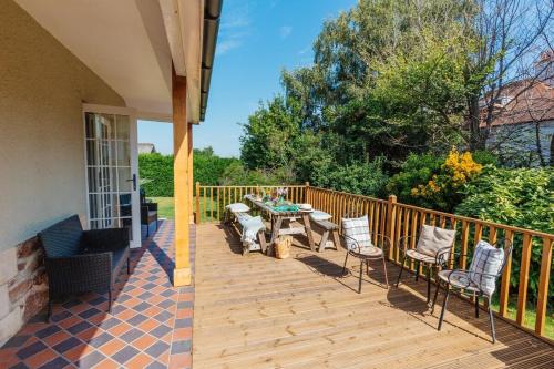 a patio with a table and chairs on a deck at Westholme Lodge in Minehead