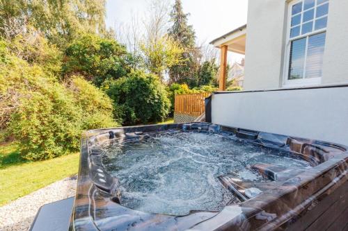 a hot tub in the backyard of a house at Westholme Lodge in Minehead