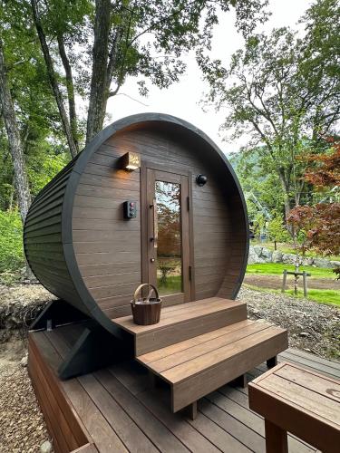 a circular building with a bench on a wooden deck at soil Hakuba in Hakuba